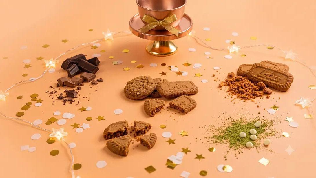Cookies set out with fairy lights and a small brass stand for a festival