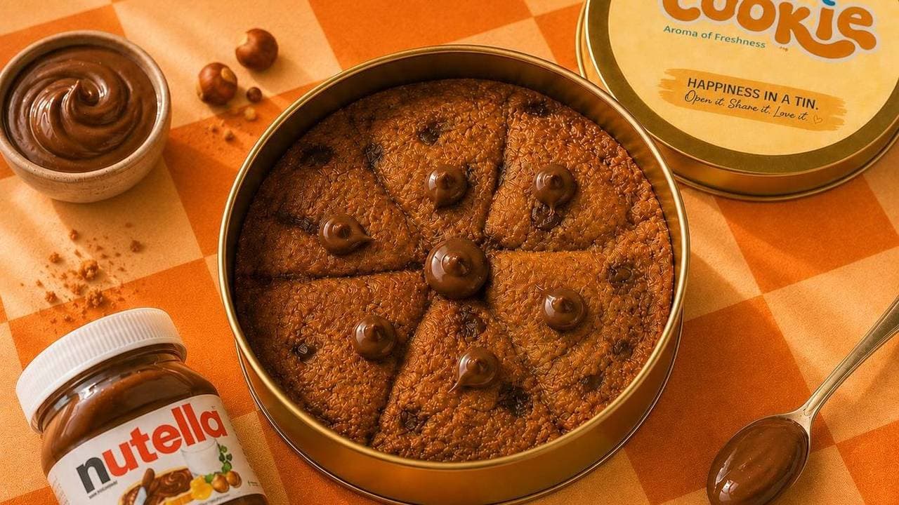 Nutella cookie tin cut into slices, with a jar of Nutella and hazelnuts beside it